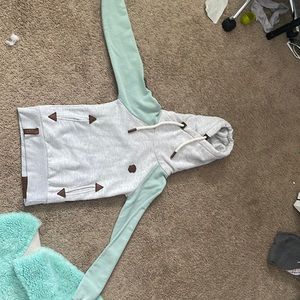 selling a new Naketano sweatshirt with teal sleeves and the rest white grey